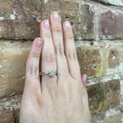 Princess-Shaped Round Diamond Cluster Engagement Ring with Halo and Twist Shank on hand
