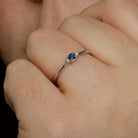 White Gold Blue Sapphire and Diamond Three-Stone Ring being worn on hand