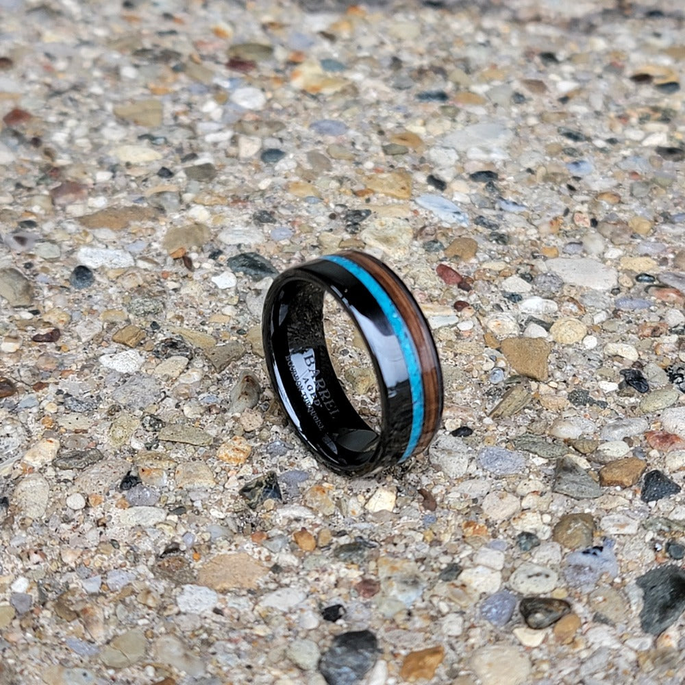 8mm Black Ceramic Band with Turquoise and Bourbon Barrel Inlay on concrete background