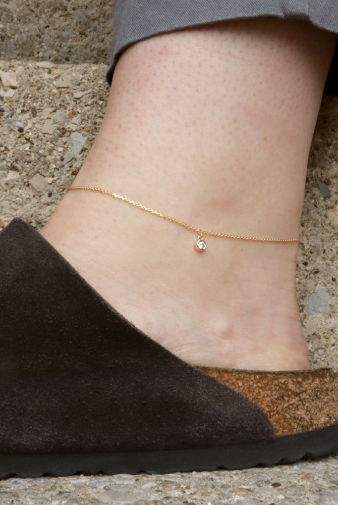 Gold Ankle Bracelet with Diamond Charm on a model